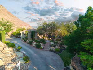 Mediterranean / spanish-style home featuring a mountain view, a tiled roof, stairs, and stucco siding