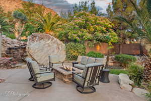 Patio terrace at dusk featuring an outdoor fire pit and a patio