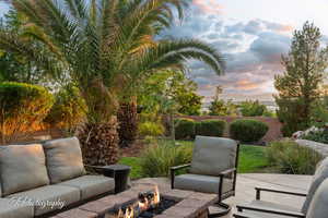 Patio terrace at dusk with an outdoor fire pit and a patio area