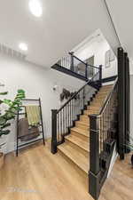 Stairs featuring wood finished floors and baseboards