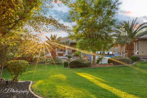 Yard at dusk with a lawn and an outdoor pool