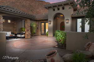 Patio terrace at dusk featuring french doors, a patio area, and outdoor lounge area