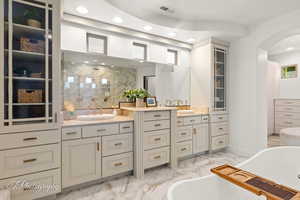 Bathroom with marble look tile flooring, vanity, a soaking tub, recessed lighting, and a walk in shower