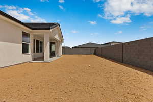 Fenced backyard featuring a patio