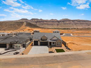 Aerial view of property and surrounding area with a mountainous background