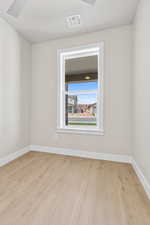 Unfurnished room featuring wood finished floors and baseboards