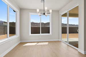 Unfurnished sunroom with a chandelier and a mountain view