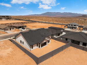 Aerial perspective of suburban area featuring a mountain backdrop and a desert landscape