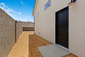 Property entrance with stucco siding and a mountain view