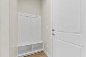 Mudroom featuring light wood finished floors and baseboards