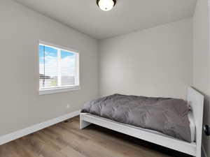 Bedroom featuring baseboards and wood finished floors