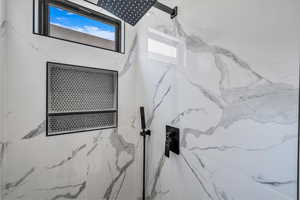 Bathroom view of a marble finish shower