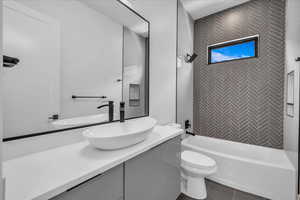 Bathroom featuring vanity, tub / shower combination, and toilet