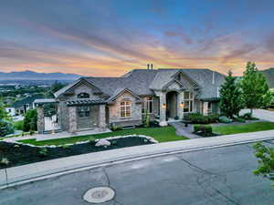 French country style house with stone siding, a standing seam roof, a yard, a mountain view, and a pergola