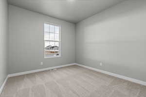 Empty room with carpet and baseboards