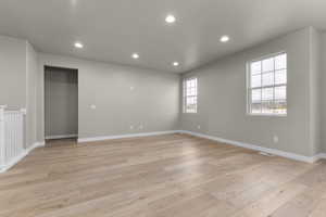 Spare room with light wood-style floors, recessed lighting, and baseboards