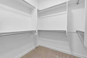 Spacious closet with carpet floors