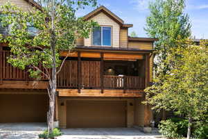 Rear view of house with a garage and driveway