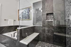 Full bathroom with a stall shower and a bath