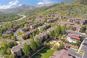 Aerial view of property's location with nearby suburban area and mountains