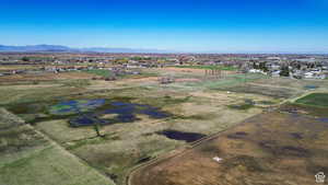 Aerial view of property's location featuring a mountainous background