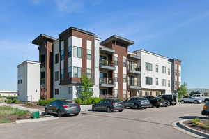 View of building exterior with uncovered parking