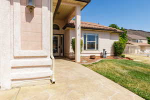 Doorway to property with stucco siding and a tiled roof