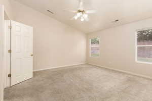 Primary Bedroom, vaulted ceiling, carpet floors, a ceiling fan, and baseboards