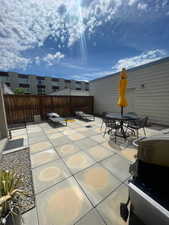 View of patio featuring outdoor dining space and in-ground gas firepit.