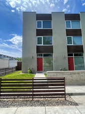 View of building exterior featuring a fenced front yard