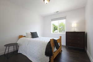 Bedroom with baseboards and dark wood-style floors