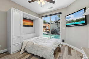 Bedroom with access to outside, wood finished floors, baseboards, and ceiling fan