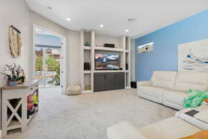 Living area featuring carpet flooring and recessed lighting
