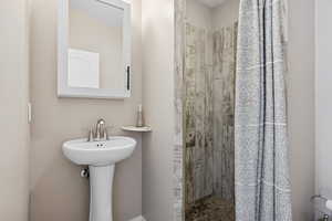 Full bathroom featuring a tile shower