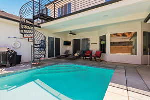 Swimming pool featuring ceiling fan and a patio