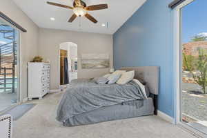 Bedroom featuring light colored carpet, access to exterior, arched walkways, recessed lighting, and baseboards