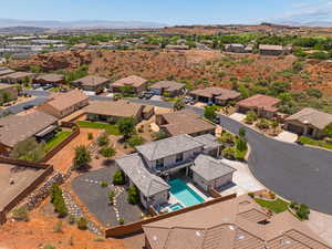 Aerial perspective of suburban area featuring mountains and a pool area