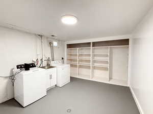 Washroom featuring washer and clothes dryer and cabinet space