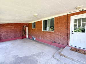 Property entrance featuring brick siding