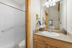 Bathroom featuring vanity and a stall shower