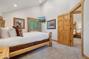 Bedroom with carpet flooring, high vaulted ceiling, recessed lighting, and baseboards
