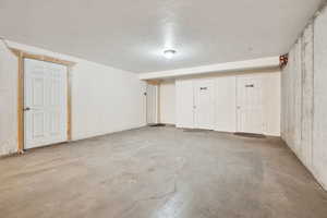 View of garage and owner's storage closets