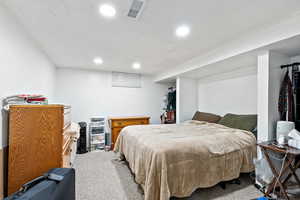 Carpeted bedroom with recessed lighting