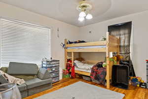 Bedroom with wood finished floors and ceiling fan