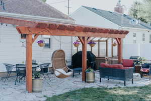 View of patio featuring a pergola, a grill, and an outdoor living space