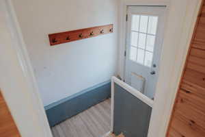 Doorway with light wood finished floors