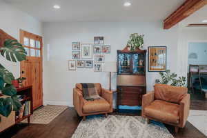 Living area with recessed lighting, beamed ceiling, baseboards, and wood finished floors