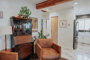 Sitting room featuring recessed lighting, beamed ceiling, and marble finish floors
