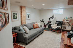 Living area with wood finished floors and recessed lighting