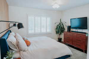 Bedroom with baseboards and wood finished floors
